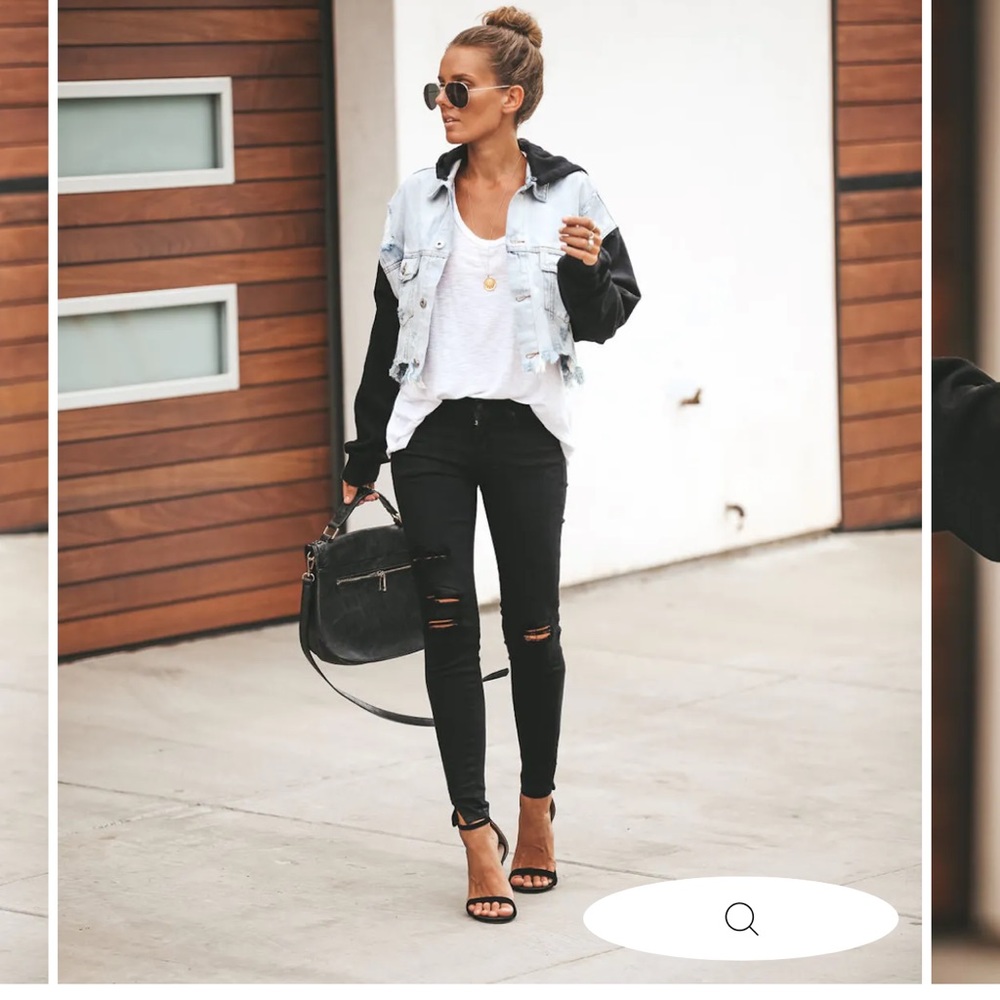 Cropped denim jacket with black hoodie sleeves and detachable hoodie.